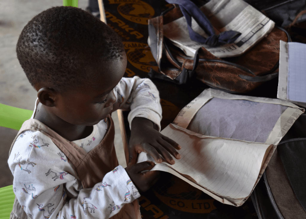 Tanzania preschool student with notebook